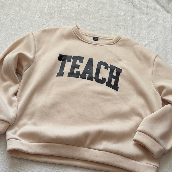 SHEIN Tops - Cream Sweatshirt with Black 'TEACH' Print